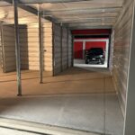 Car ready to enter a 10x20 pull-through storage unit next to a standard 10x20 unit at Potter Storage in Morton, IL.