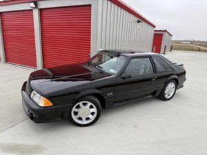 Black Ford Mustang parked in front of storage units at Potter Storage in Morton IL for vehicle storage